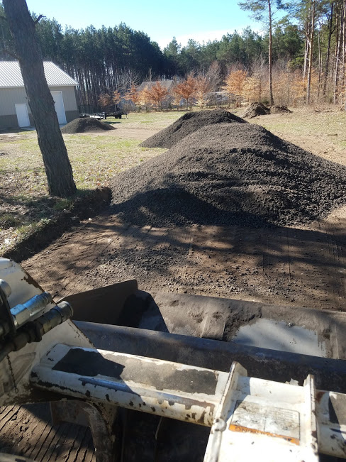 Here we had removed the grass and sod from the area, sprayed herbicide on the area to prevent from growing back. This picture was toking from the skid-loader after the milling were delivered and before spreading them