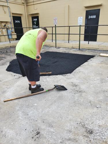 This was a bad area in the asphalt surface that was saw cut then the old asphalt was removed and in this picture We are raking the new asphalt. After this process compact the new asphalt and let it cure or cool before allowing traffic back onto it.  